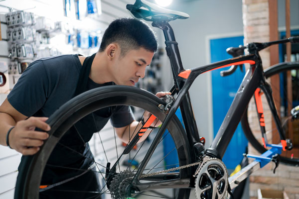 Photo of a business owner working on a bicycle