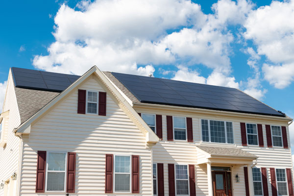 Home with rooftop solar panels that may affect homeowners insurance rates